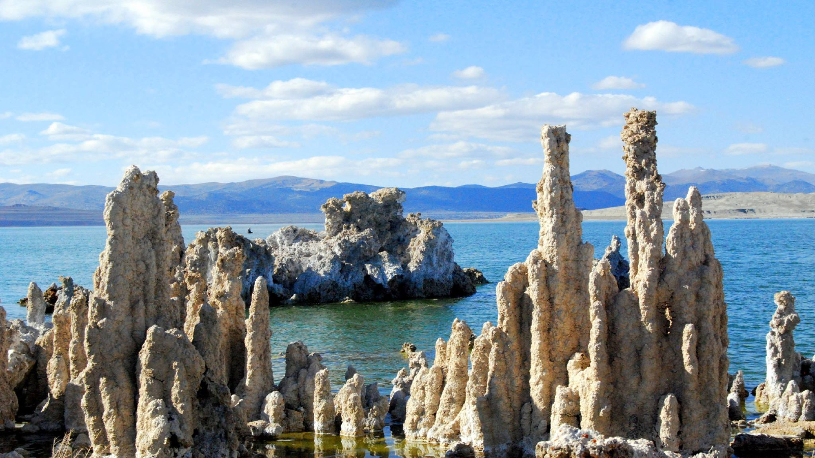 A series of rock formations stand on the edge of Lake Mono