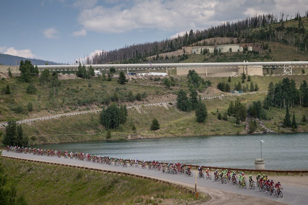 The peloton passes by a huge mining operation during stage 2 of the USA pro Challenge.