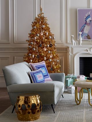 A living room with a brightly-lit Christmas tree