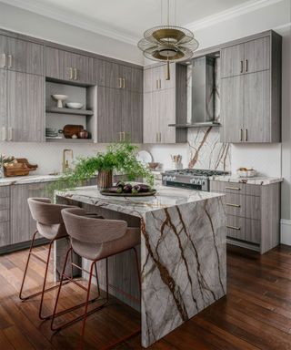 Marble kitchen with kitchen island and gray cabinetry