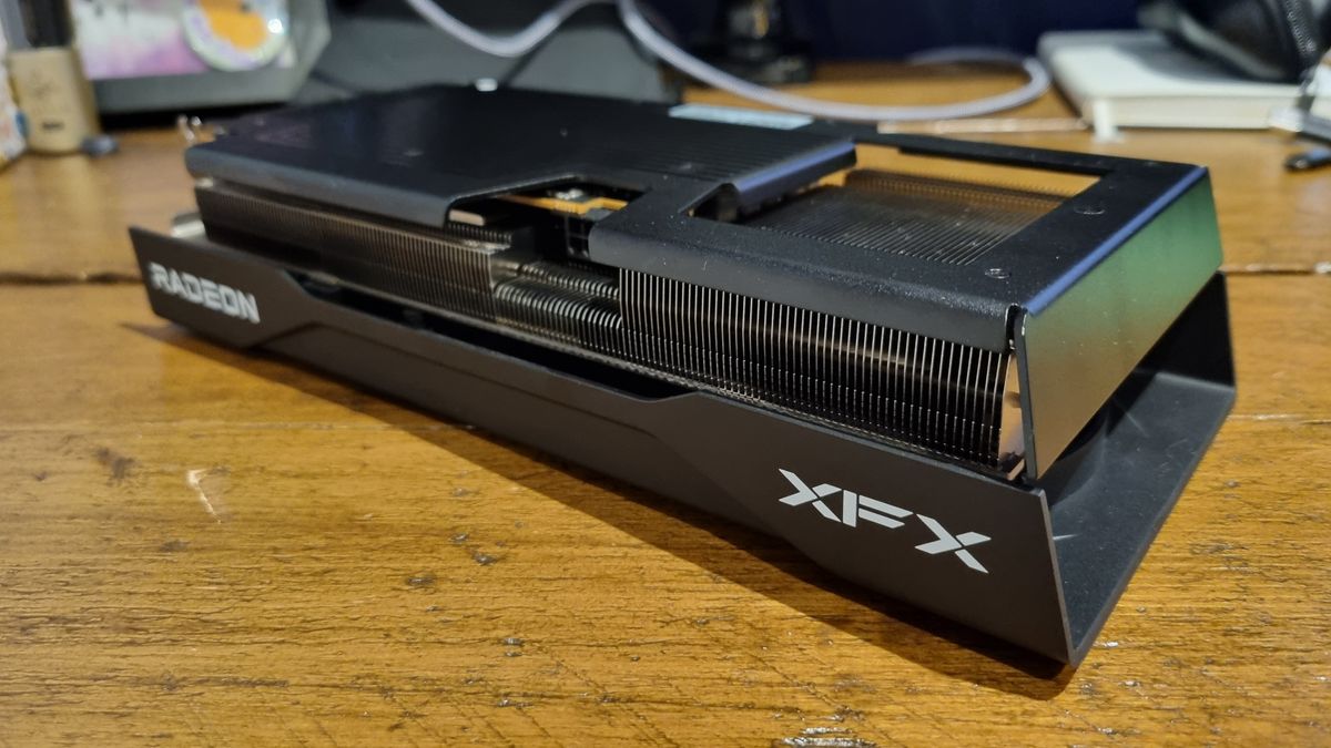 The XFX Swift RX 9060 XT on a wooden desk