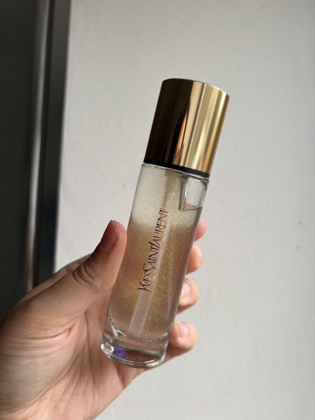 Mica Ricketts holding YSL Touche &amp;Eacute;clat Blur Primer