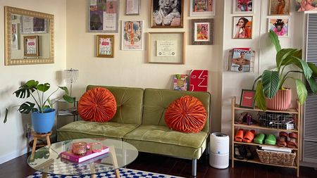 Living room with green couch and wall art