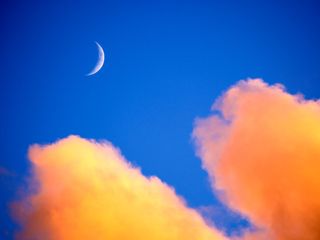 Clouds and new moon at sunset over Padstow, Cornwall, UK.