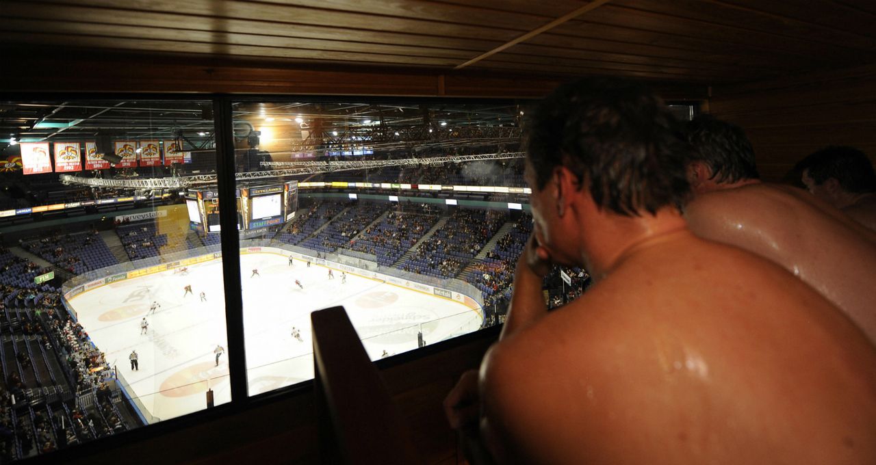 Spectators watch the Liiga ice hockey match from a sauna box in Helsinki.