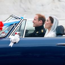 Prince William and Princess Kate riding in a convertible on their wedding day