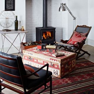 fireplace with armchair and white walls