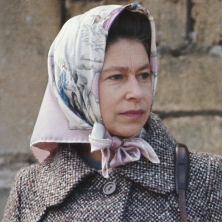 Queen Elizabeth wearing a pink head scarf and tweed jacket