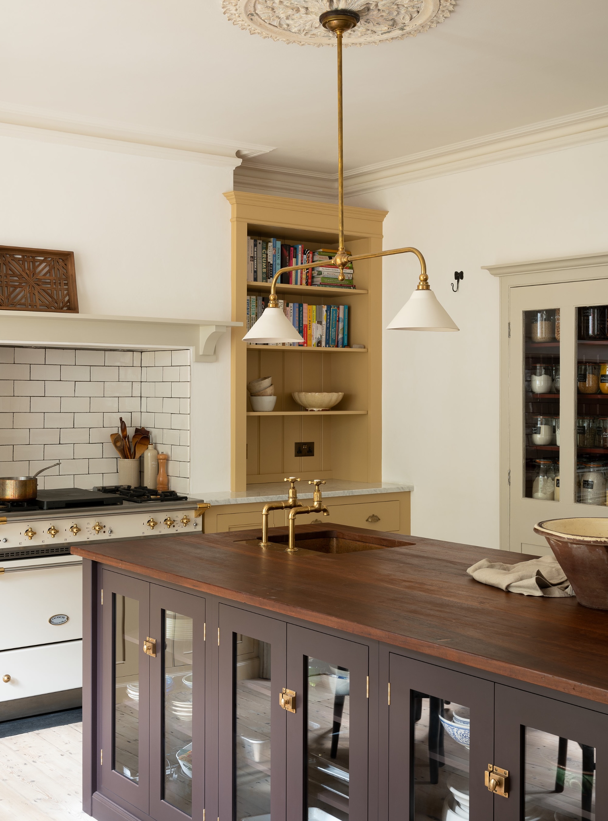 chocolate brown kitchen island in yellow kitchen by devol