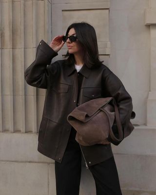 Francesca wears a brown suede bag