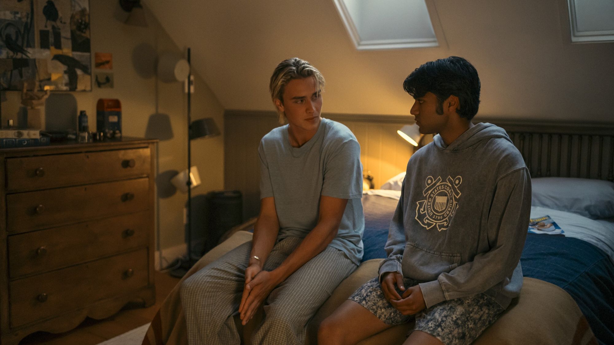 Joseph Zada and Shubham Maheshwari sitting on a bed in We Were Liars
