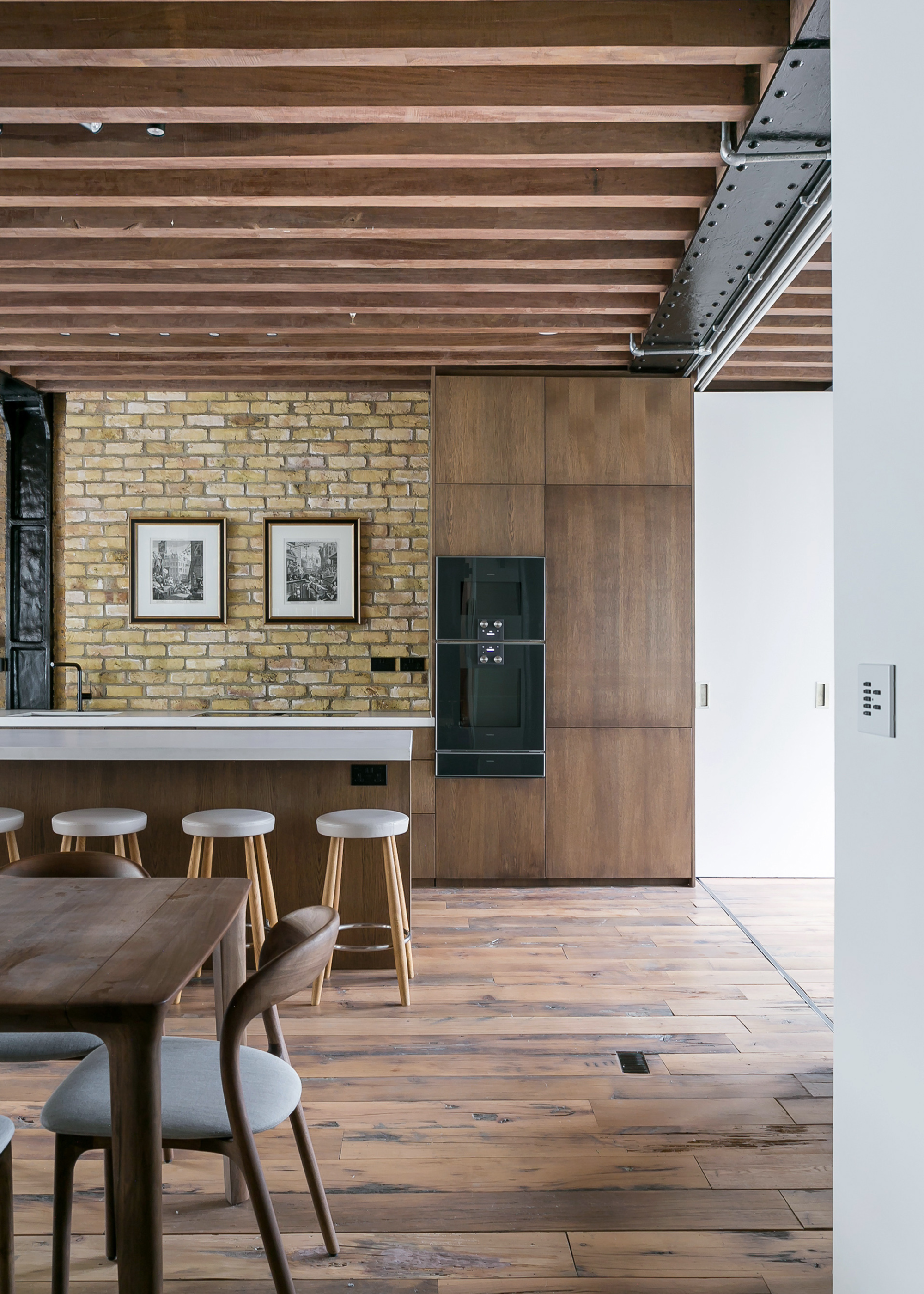 a cool modern loft apartment with wooden beams on the ceiling and a wooden kitchen design