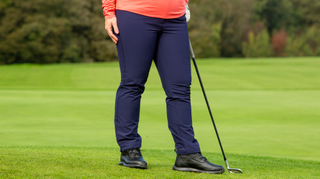 A golfer poses in the Callaway Thermal Ladies Golf Pants