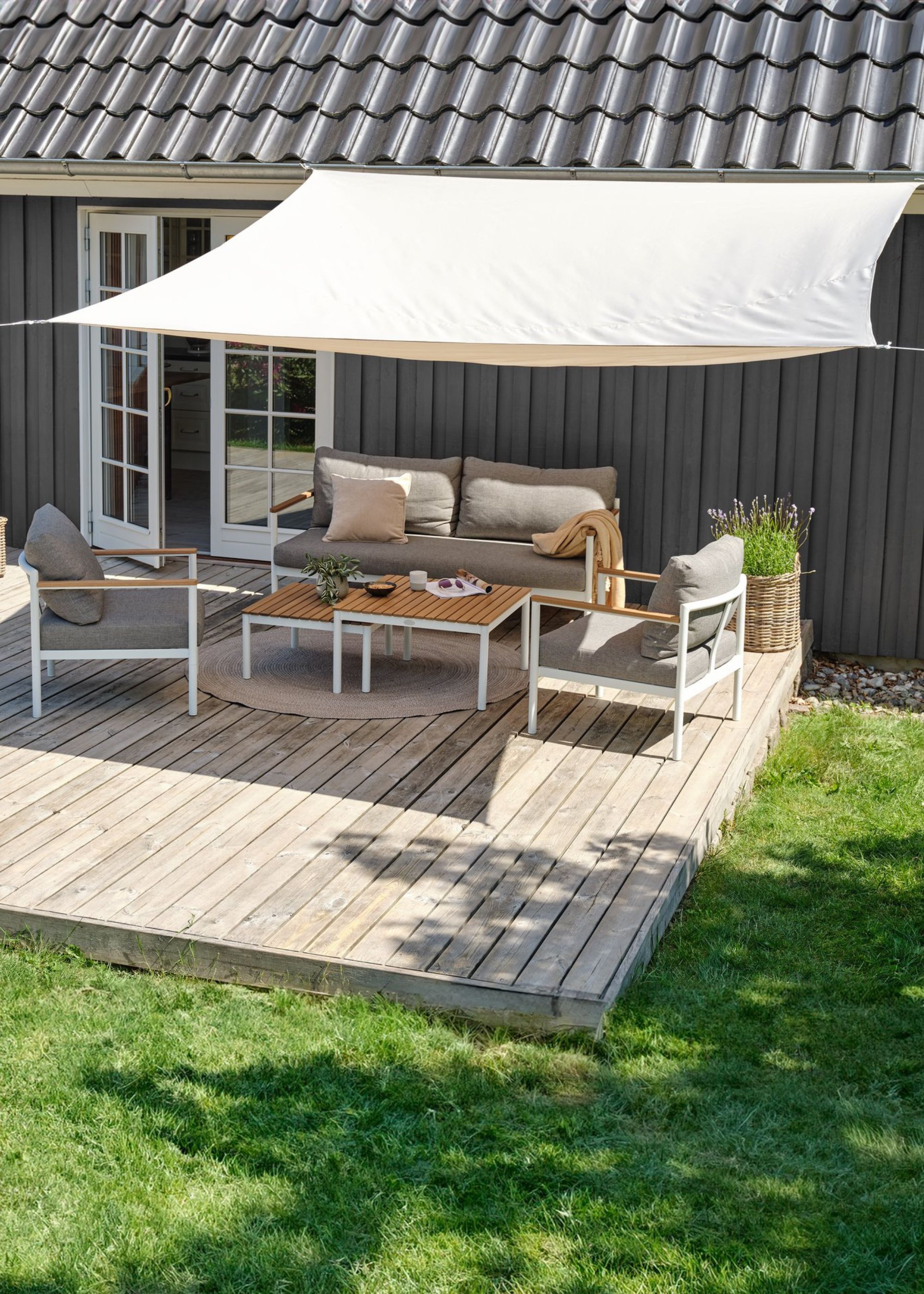 A shade soil above outdoor furniture on a patio