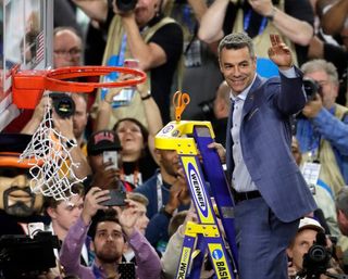 Virginia head coach Tony Bennett cuts down the net following the championship game against Texas Tech in the Final Four NCAA college basketball tournament, Monday, April 8, 2019, in Minneapolis. Virginia won 85-77 in overtime. (AP Photo/Matt York)