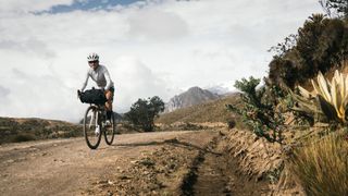 Bikepacker riding on dirt road