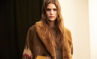 Model wearing a fur collared Jacket