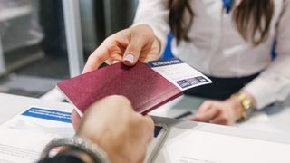 woman handing over passport