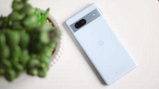 Google Pixel 7a phone on a white desk