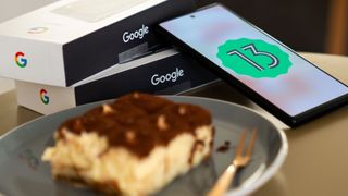 Android 13 logo on Pixel 6 with Tiramisu dessert in foreground