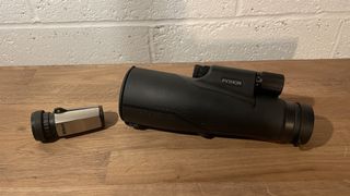 Two monoculars on a wooden table