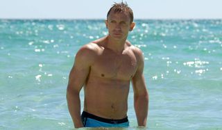 Daniel Craig stands in the water in his bathing suit in Casino Royale.