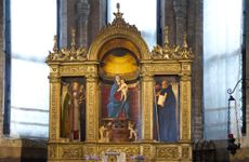 The Virgin and Child with Saints Nicholas of Bari, Peter, Mark and Benedict, better known as the Frari Triptych, 1488–89. Central panel: 72in by 31in; lateral panels: 45in by 18in. By Giovanni Bellini (about 1435–1516), Church of Santa Maria Gloriosa dei Frari, Venice.