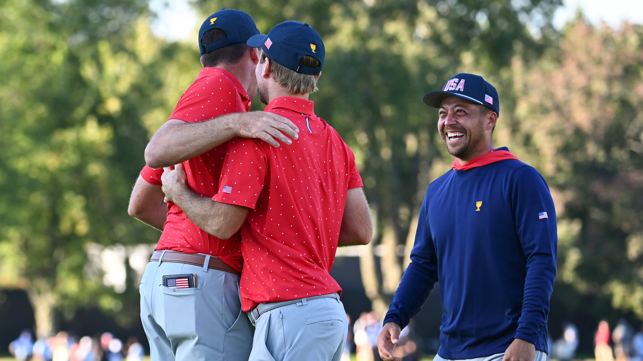 Xander Schauffele greets Keegan Bradley on the putting green