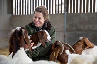 Laura Corbett, goat farmer, Wiltshire. She is pictured here two of her rare breed White Park cattle. Photograph: Millie Pilkington/Country Life Picture Library OVERS