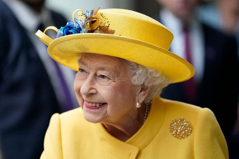 Queen Elizabeth II reacts during her visit to Paddington Station