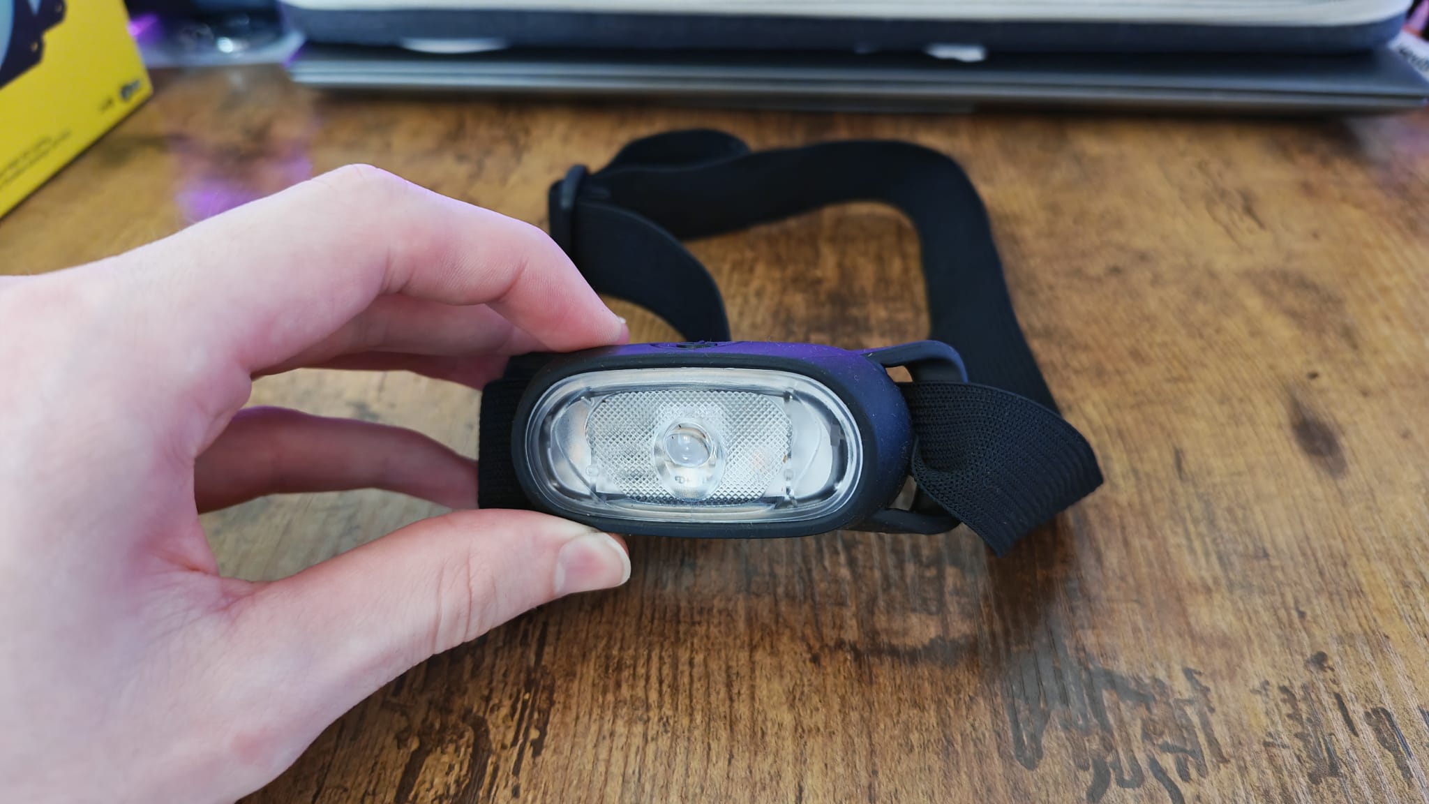 A reviewer holding a head torch used for PC building toward the camera