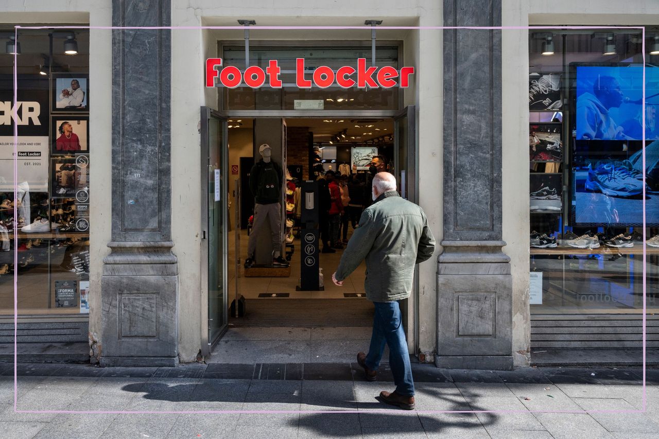 The front of a Foot Locker store with a man walking in