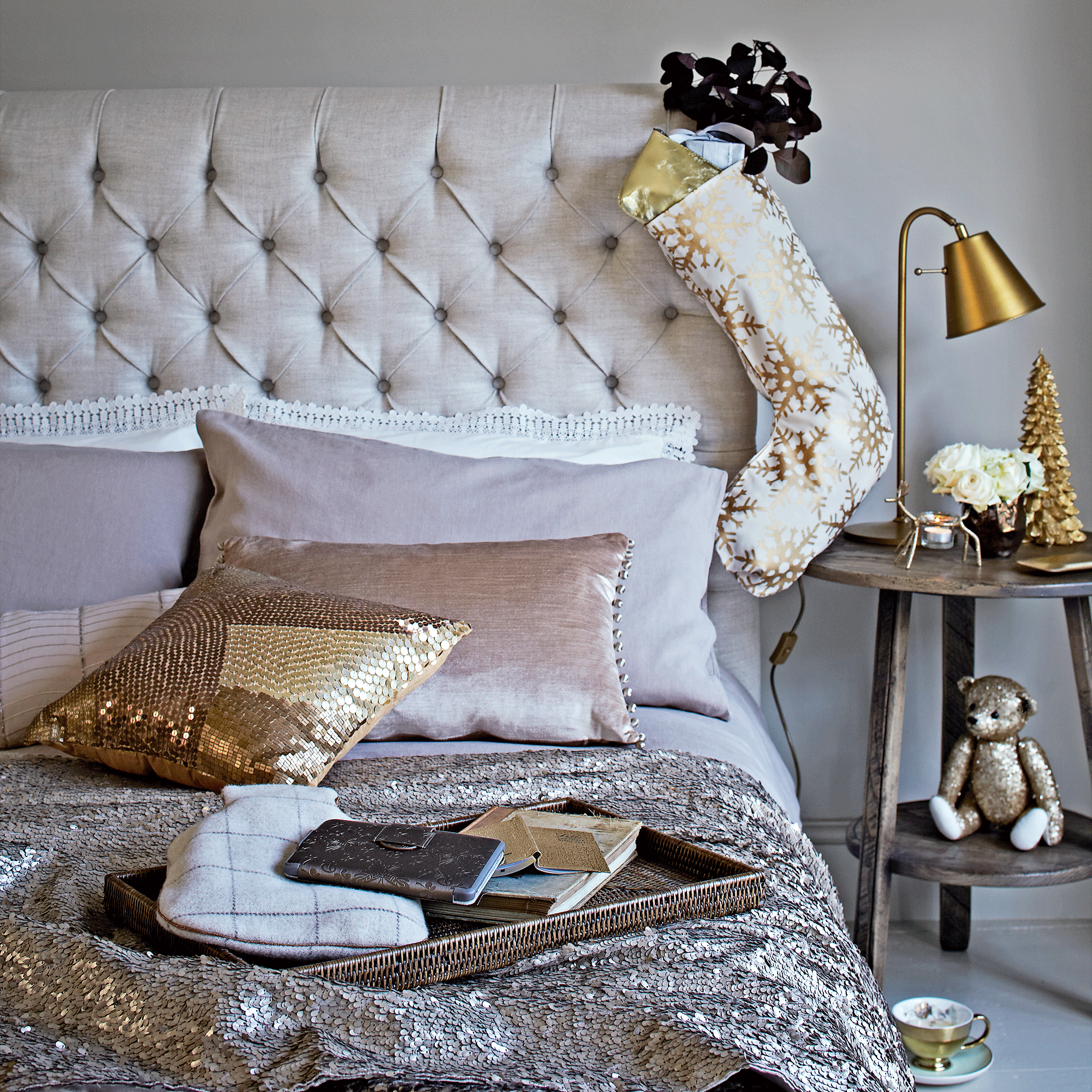 bedroom with white wall bed with designed cushions and bedside lamp