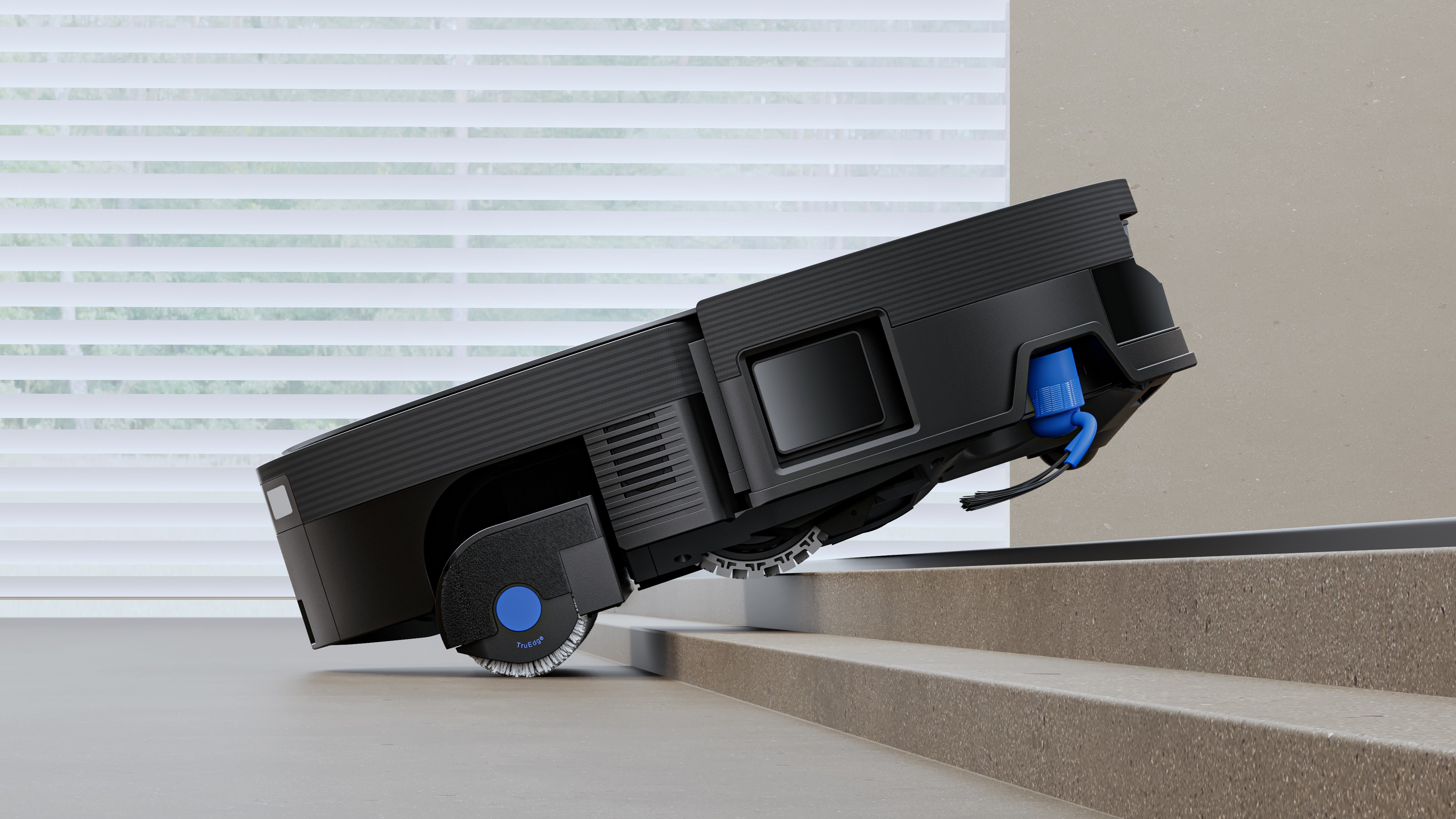 Ecovacs Deebot X12 OmniCyclone robot vacuum climbing a step