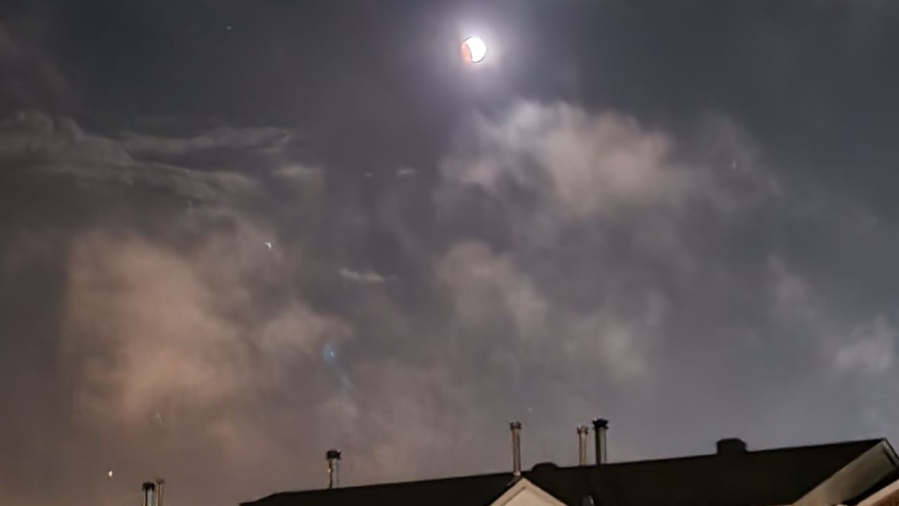 A reader in Ottawa, Canada sent a smartphone photo of the Super Flower Blood Moon just emerging over the rooftops on May 15, 2022.
