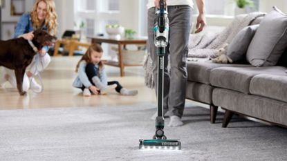 Image of one of the best cordless vacuum cleaners from Bissell being used to clean carpet 