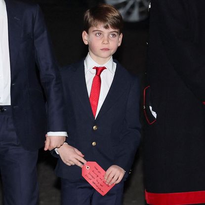 Prince Louis carrying a private message written for Kate Middleton's parents at the "Together At Christmas" Carol Service at Westminster Abbey.