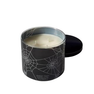 A three-wick candle in a spider web jar