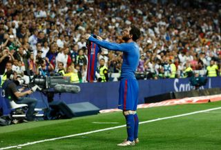 Lionel Messi holds his shirt up to the crowd after scoring a winner for Barcelona against Real Madrid in added time at the Santiago Bernabeu in April 2017.