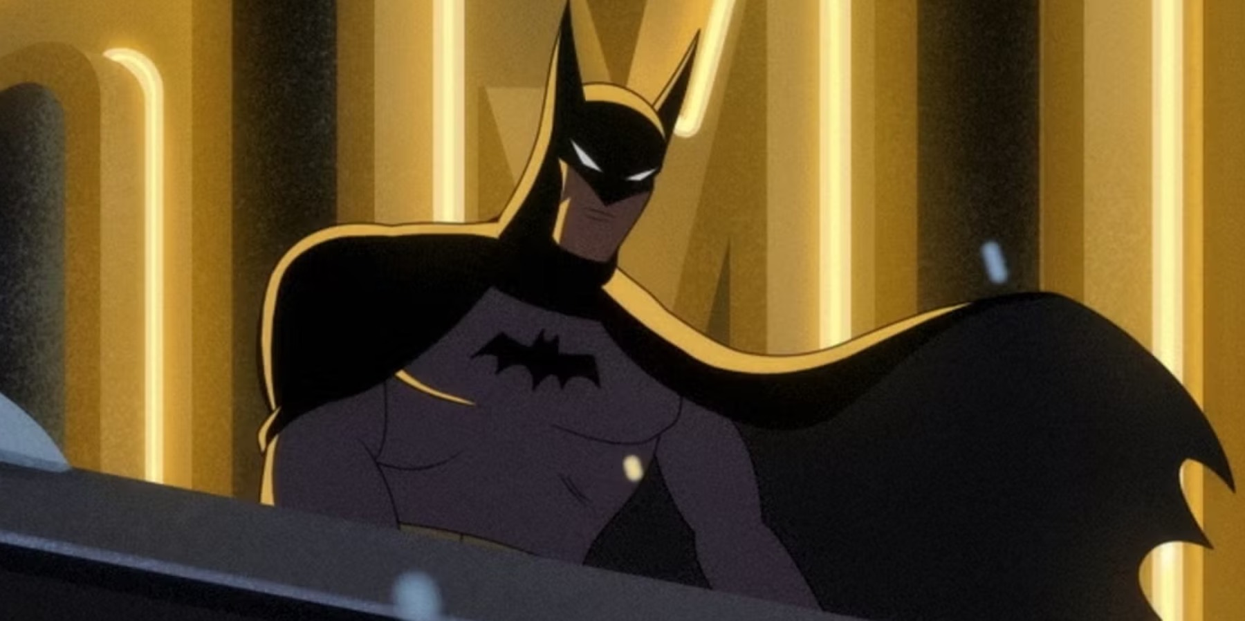 Batman looking down from a rooftop