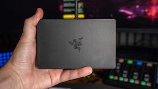 Holding Razer Handheld Dock Chroma in hand