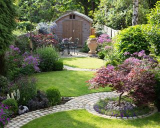 curved brick pathways in a small garden