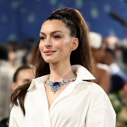 Anne Hathaway wearing a ponytail and necklace to the 2025 Met Gala