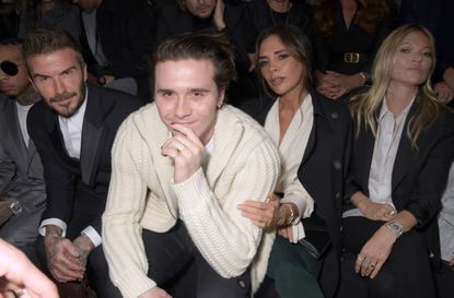 Brooklyn Beckham with parents David and Victoria Beckham