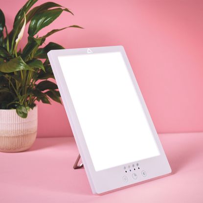 Aldi wellness lamp on a pink backdrop