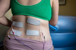 A pregnant woman in labour wearing a tens machine as pain relief