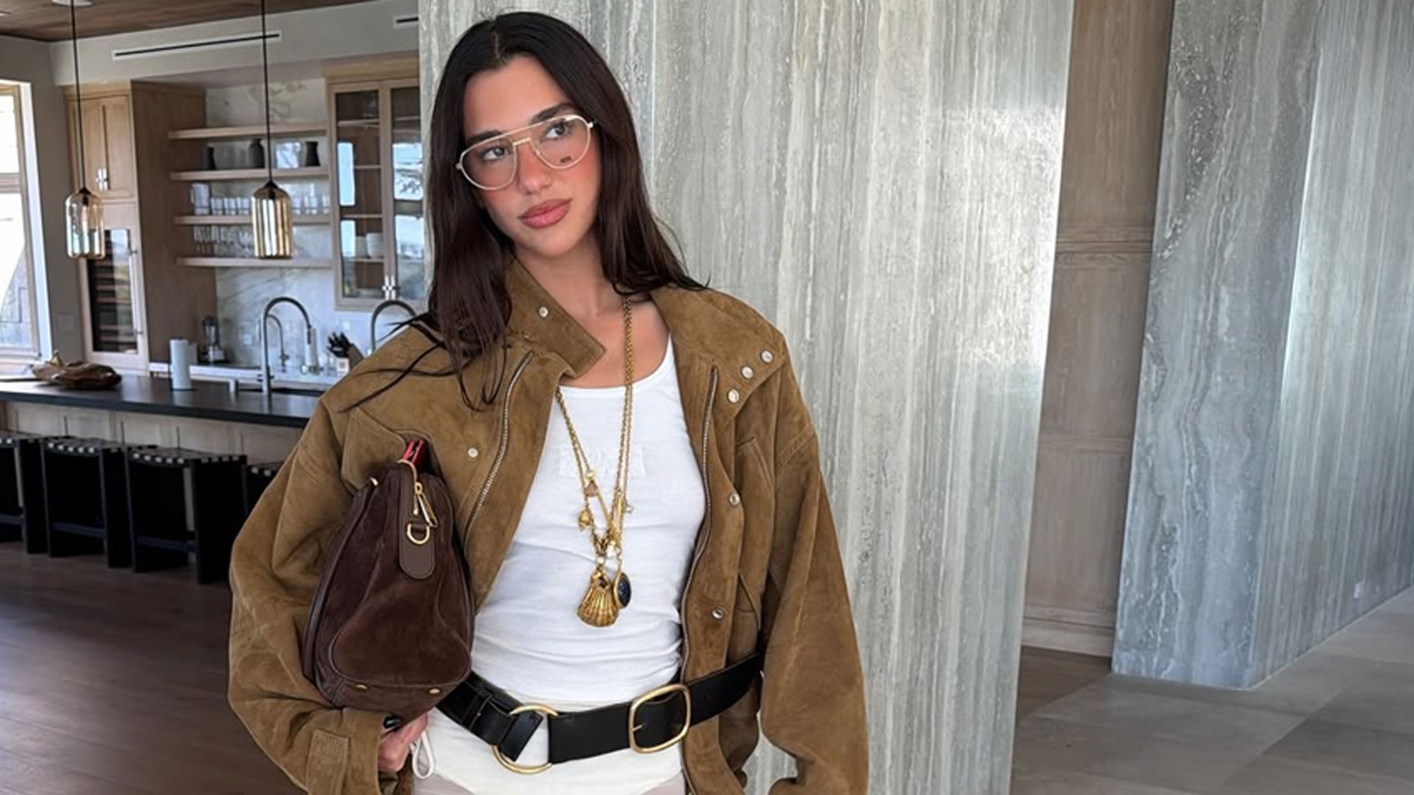 Dua Lipa carries the Gucci Borsetto bag.