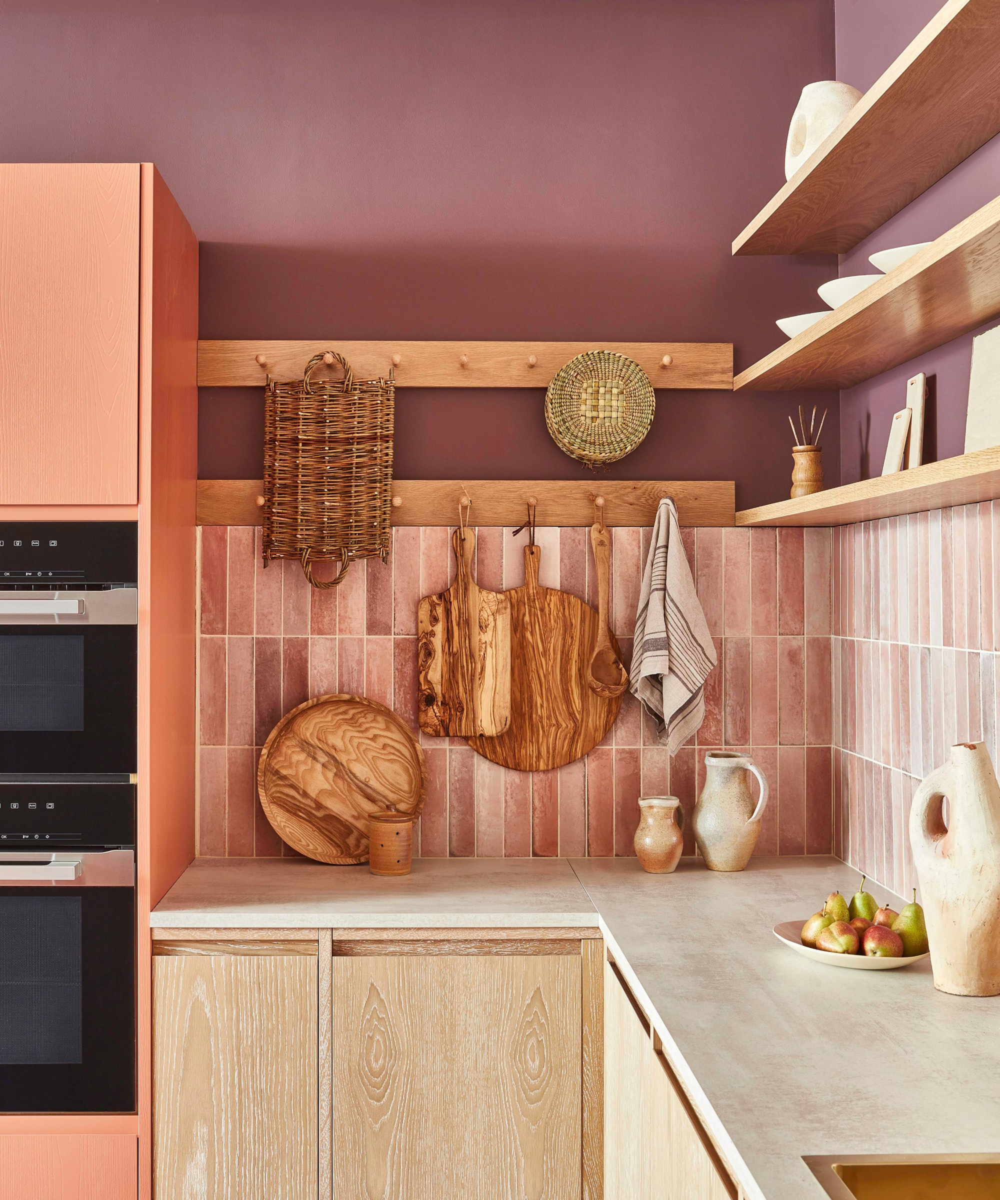 Kitchen with pink tiles and purple walls
