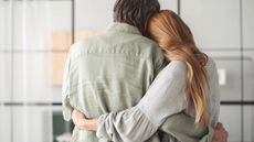 A daughter gives her father a loving hug