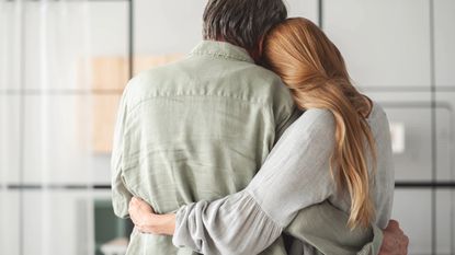 A daughter gives her father a loving hug